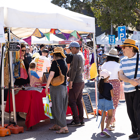 a group of people lining up at a stall